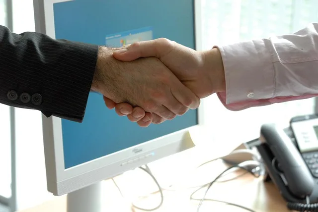 hand shake representing dental insurance options in Portugal